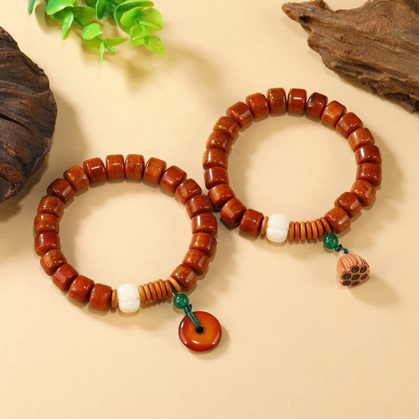 Bone bead Buddhist bracelet collection showing lotus and peace buckle charm varieties
