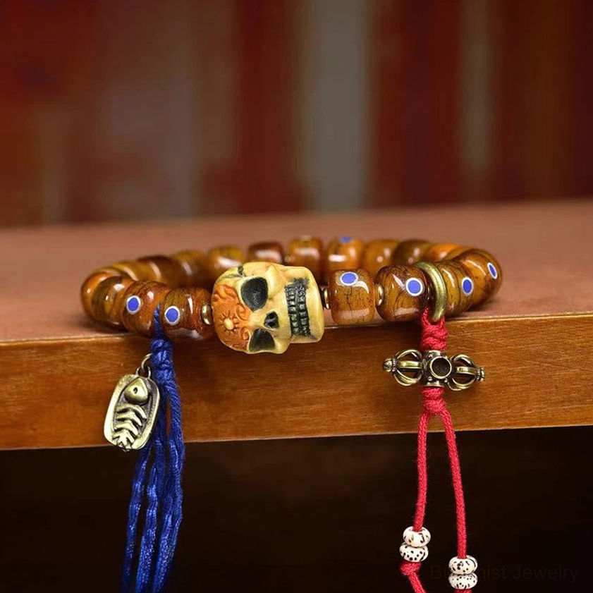 Side view of handmade bone skull bracelet with silver metal leaf pendant and elastic string band