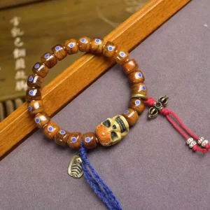 Handcrafted bone skull bracelet with inlay details and decorative tassels for Buddhist meditation and spiritual protection