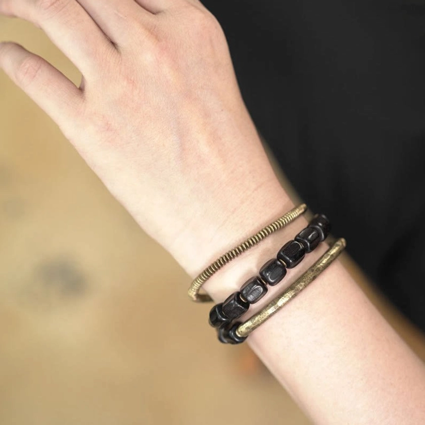 Wrist wear demonstration of multilayered Buddhist healing bracelet with ebony and copper
