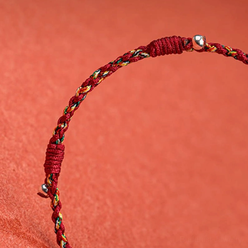 Close-up detail of braided string bracelet knot design with adjustable copper beads