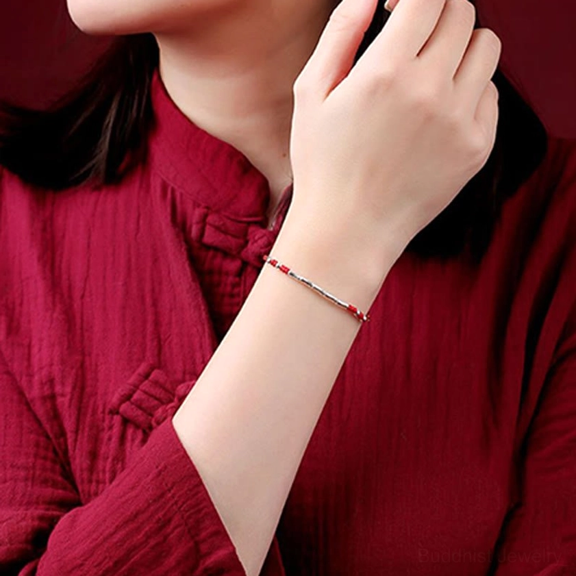 Person wearing multicolored braided protection bracelet in everyday lifestyle setting