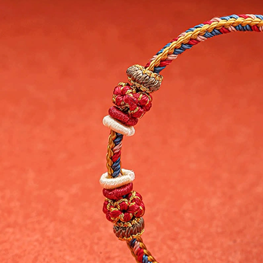 Dunhuang braided bracelet close-up side view showing twisted multicolor threads red blue gold yellow cords decorative knots