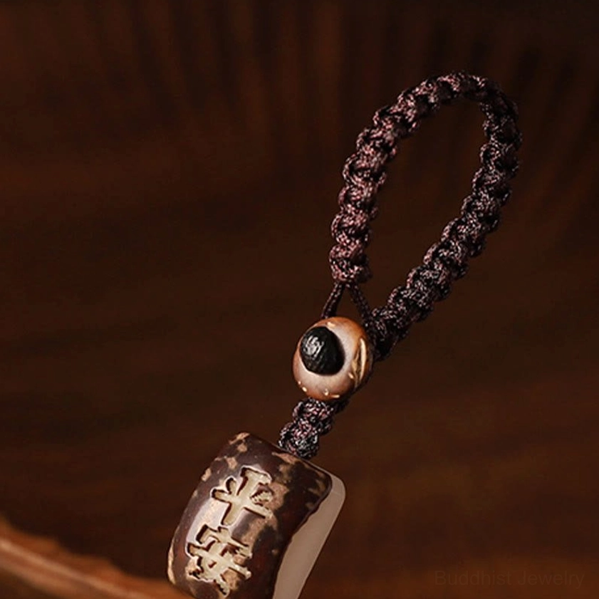 Braided keychain strap with protective beads and eye-patterned decorative bead for Buddhist money bag charm