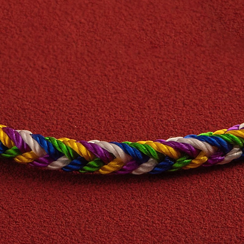 Close-up of five-color braided bracelet rope section showing woven texture and central knot detail