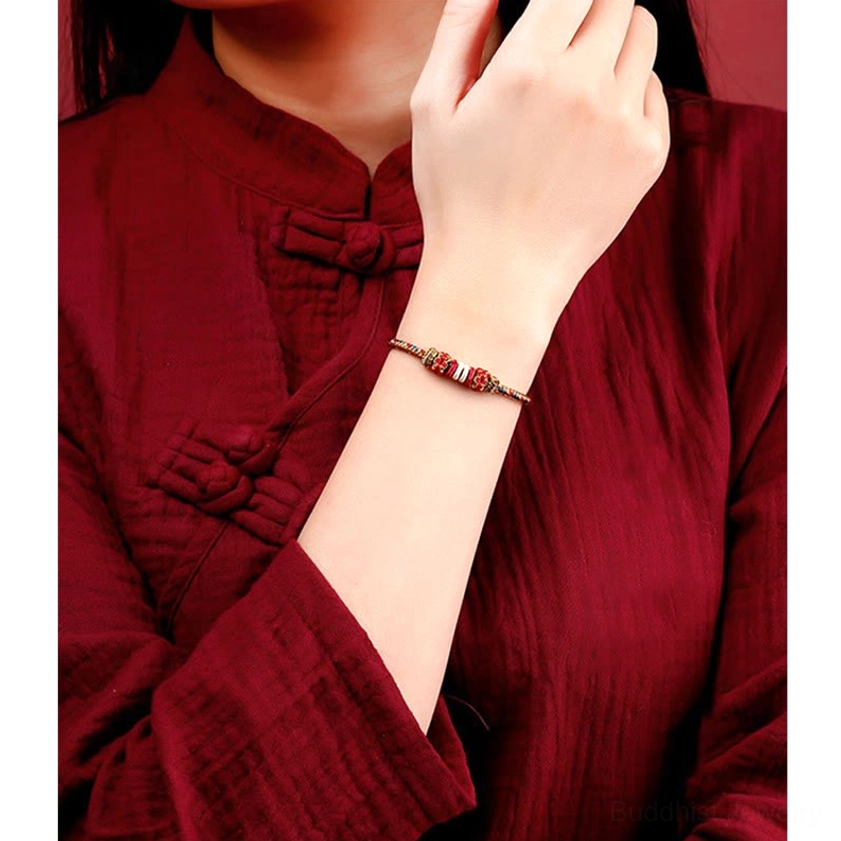 Buddhist string bracelet worn on wrist with red and gold accents traditional spiritual jewelry for protection