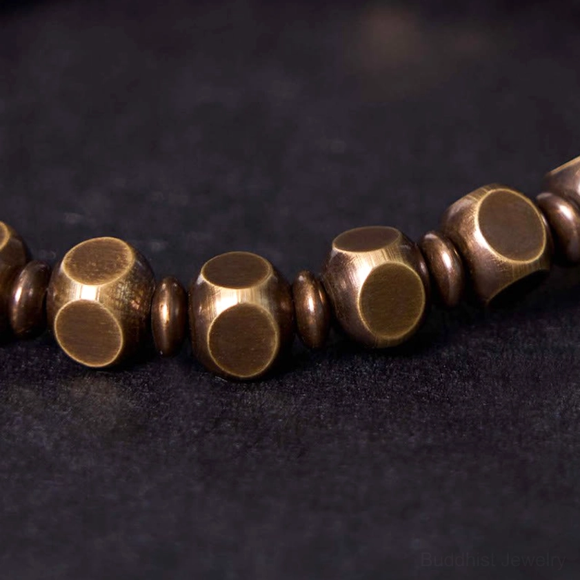 Buddhist bracelet faceted metal beads showing antique brass texture and craftsmanship