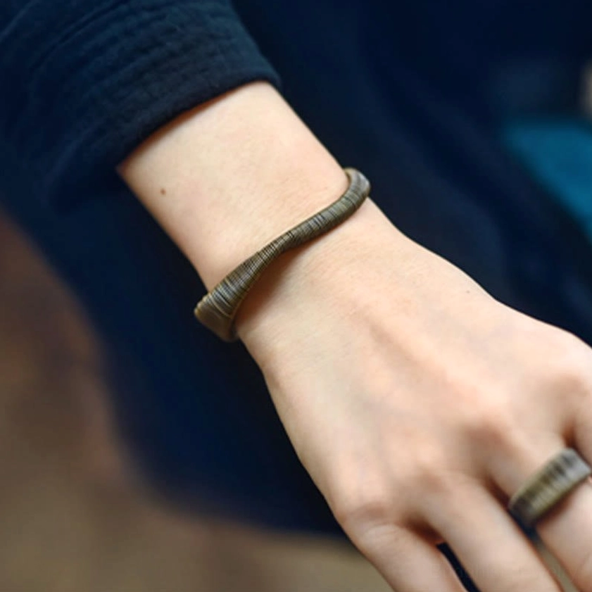Brass wrapped cuff bracelet close-up of metal texture and natural patina finish for spiritual energy conduct