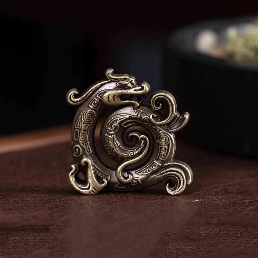 Antique brass dragon incense holder with vintage metal finish and intricate carved dragon patterns, eye-level shot on wooden table