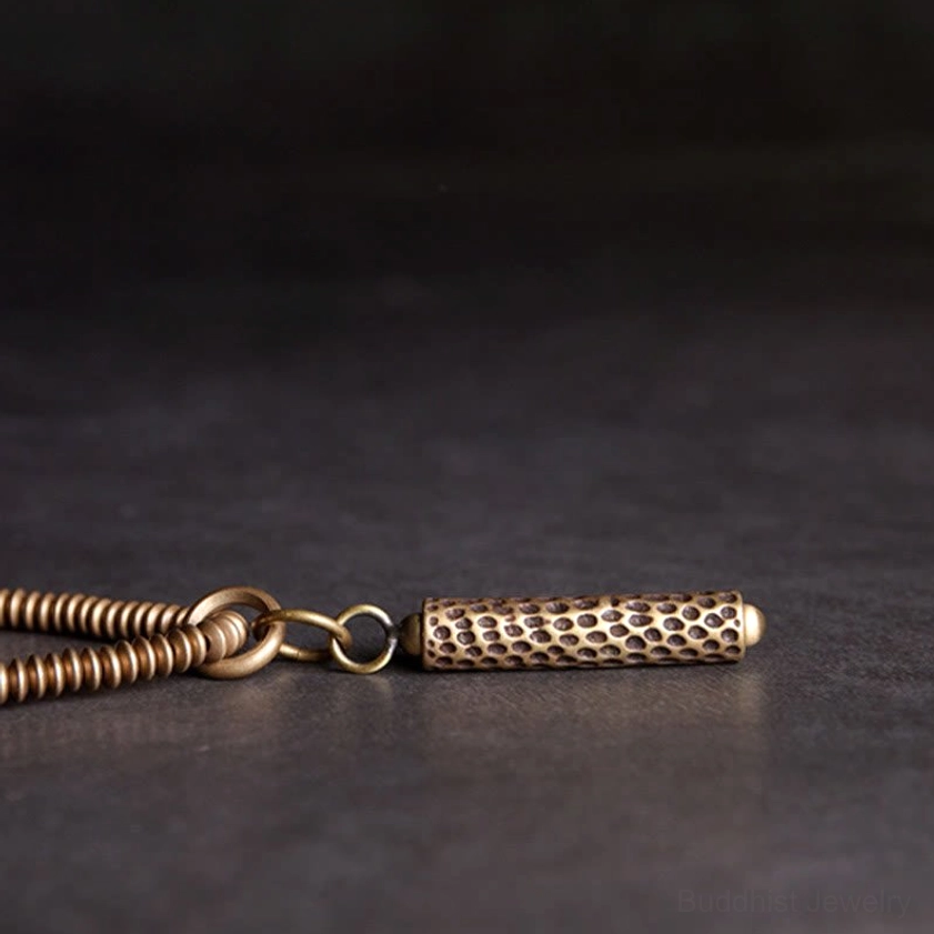 Brass pendant and metal hardware details - macro flat lay view with jump rings