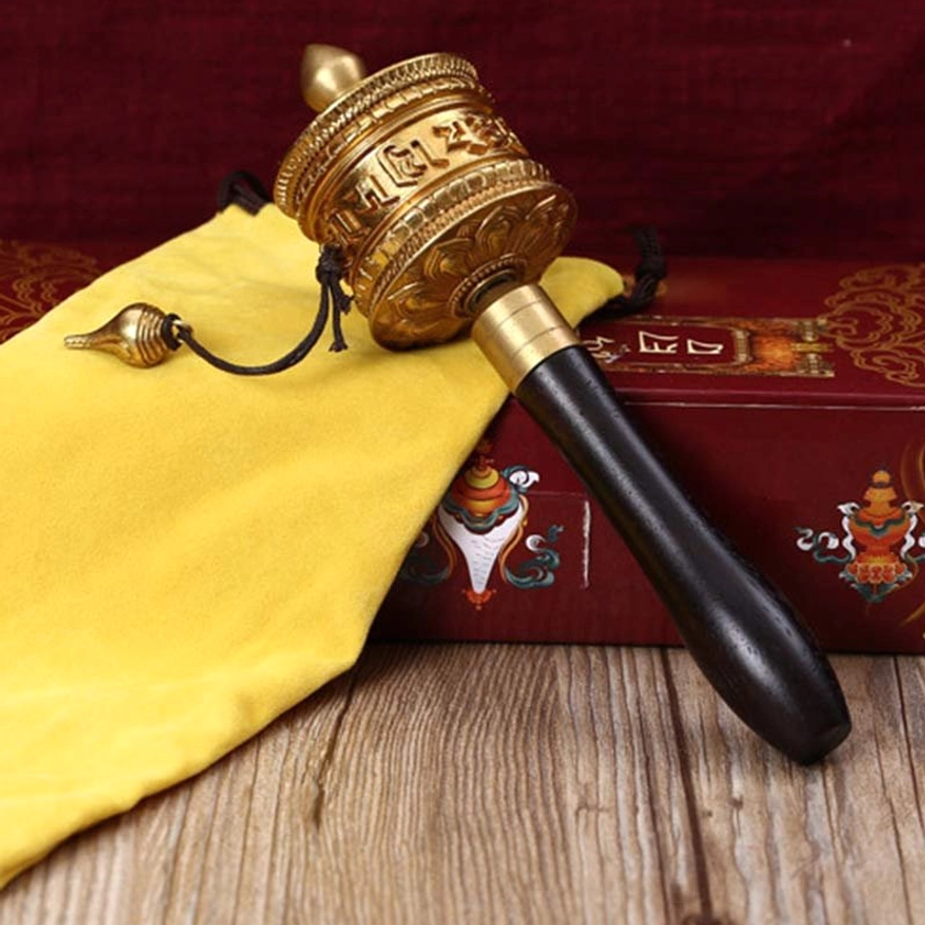 Brass Buddhist prayer wheel with dark wooden handle, hanging bell pendant, Om Mani Padme Hum spiritual decoration
