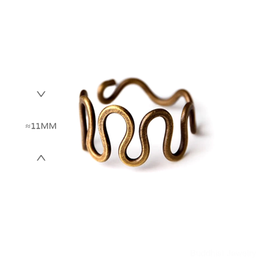 Curved brass wave ring overhead close-up with size label showing 11mm band width and antique bronze finish