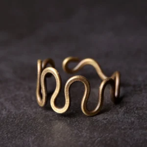 Adjustable curved brass wave ring front close-up view showing intricate wavy design and antique bronze finish