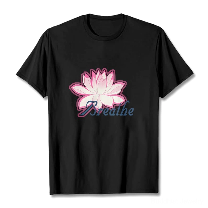 Breathe lotus flower black t-shirt flat lay with pink lotus and dark blue text on plain black background