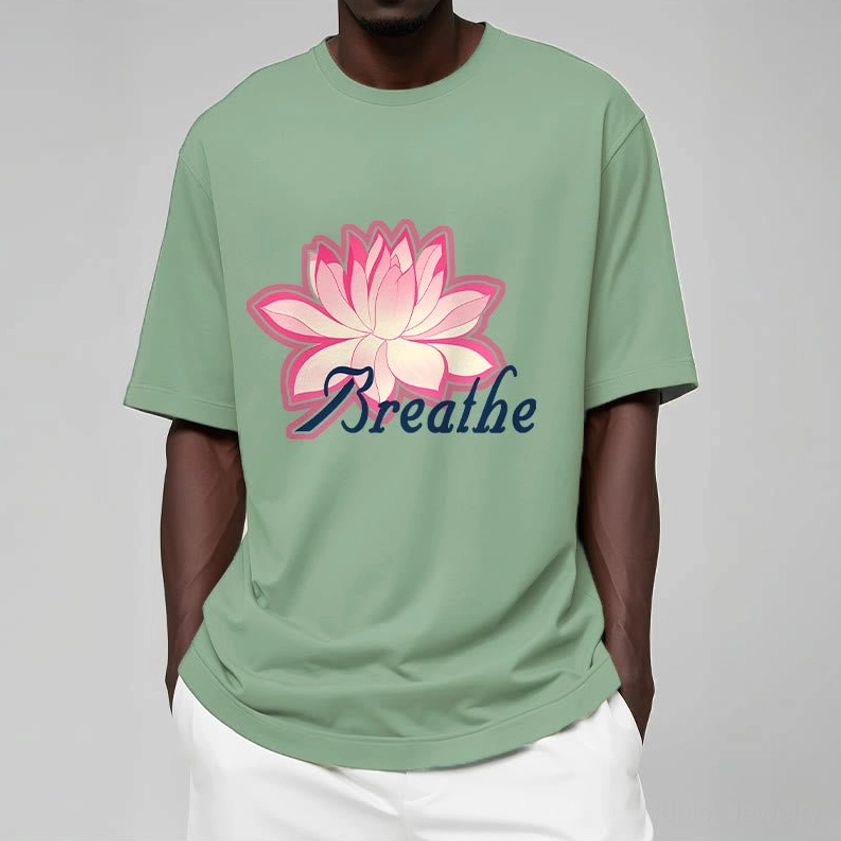 Close-up detail of breathe lotus flower t-shirt print showing pink lotus flower and dark blue text quality