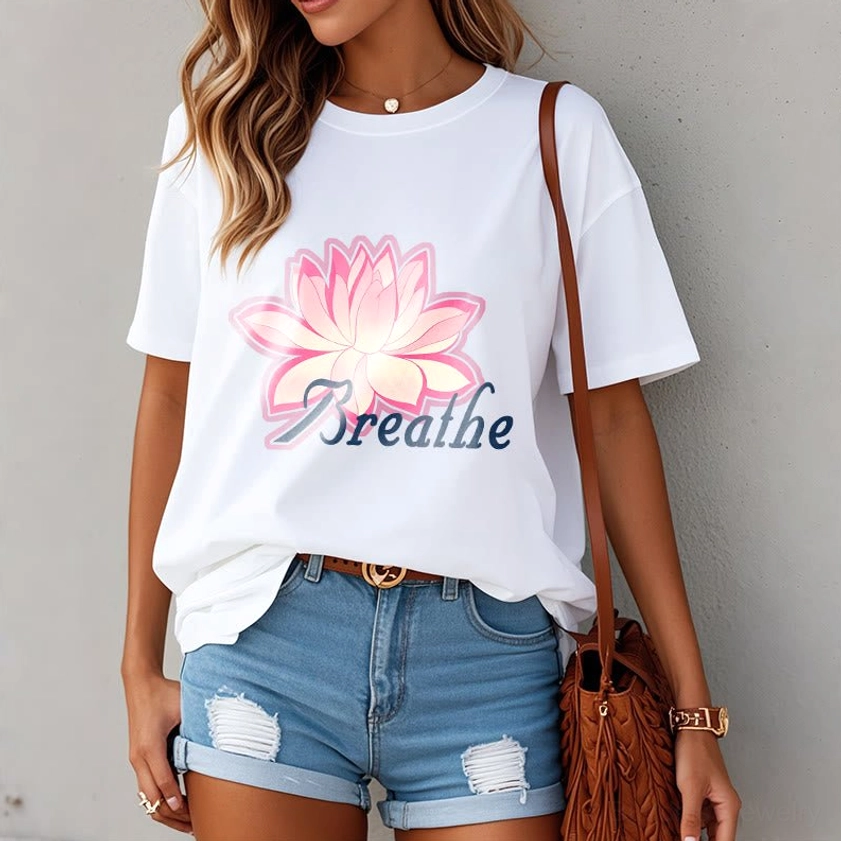 Women wearing breathe lotus flower white t-shirt with pink lotus graphic, casual daily styling scene with wooden background