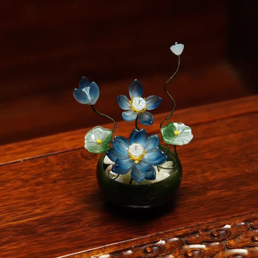 Bright blue liuli glass lotus flower pot with translucent petals ceramic base front view