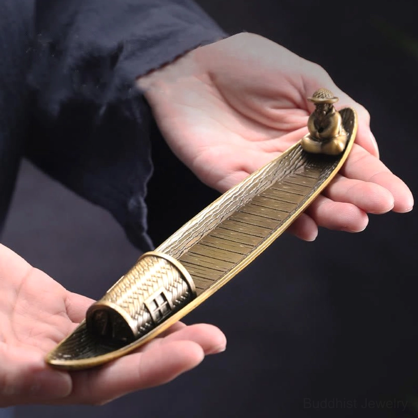 Handcrafted bronze incense burner held in hands showing antique finish and woven cabin detail