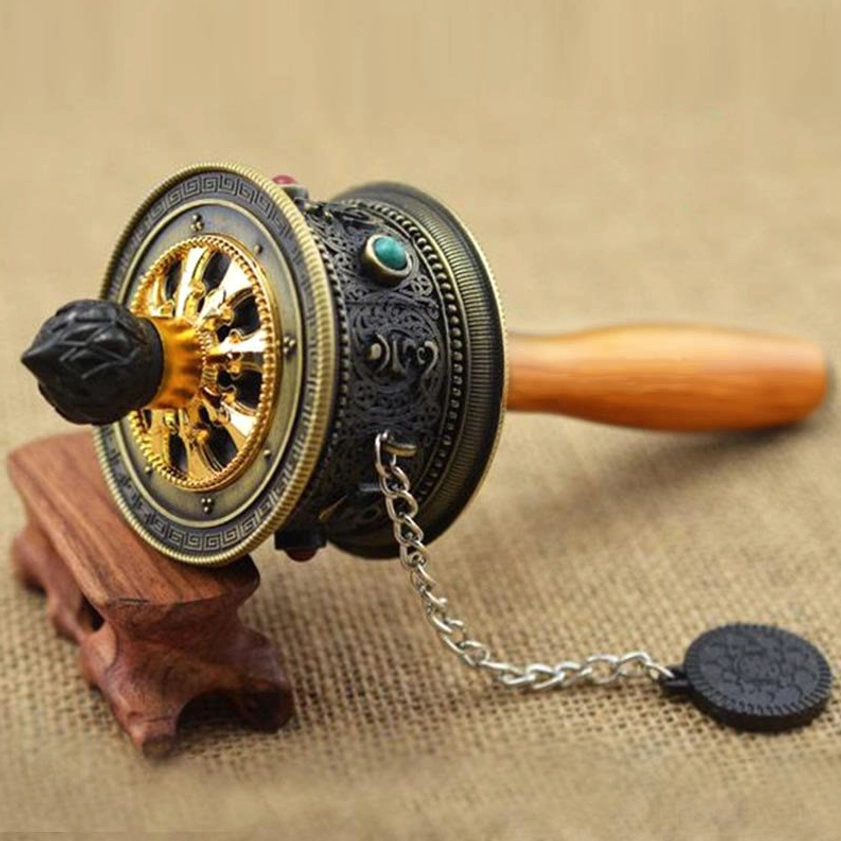 Dark bronze carved Buddhist prayer wheel with silver hanging chain and traditional pendant, showcasing detailed metalwork on stand