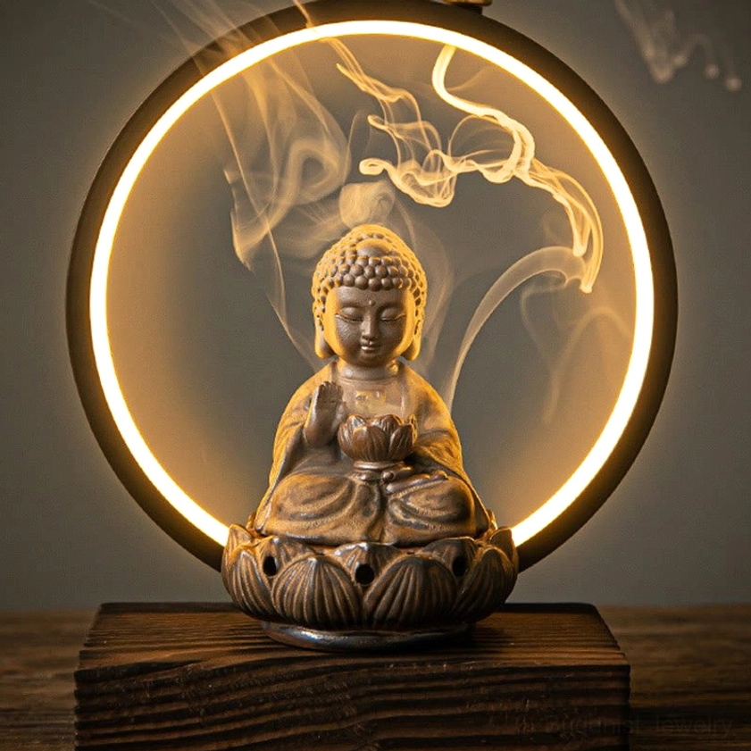 Brown unglazed ceramic Buddhist backflow incense burner with LED light showing cascading smoke waterfall effect