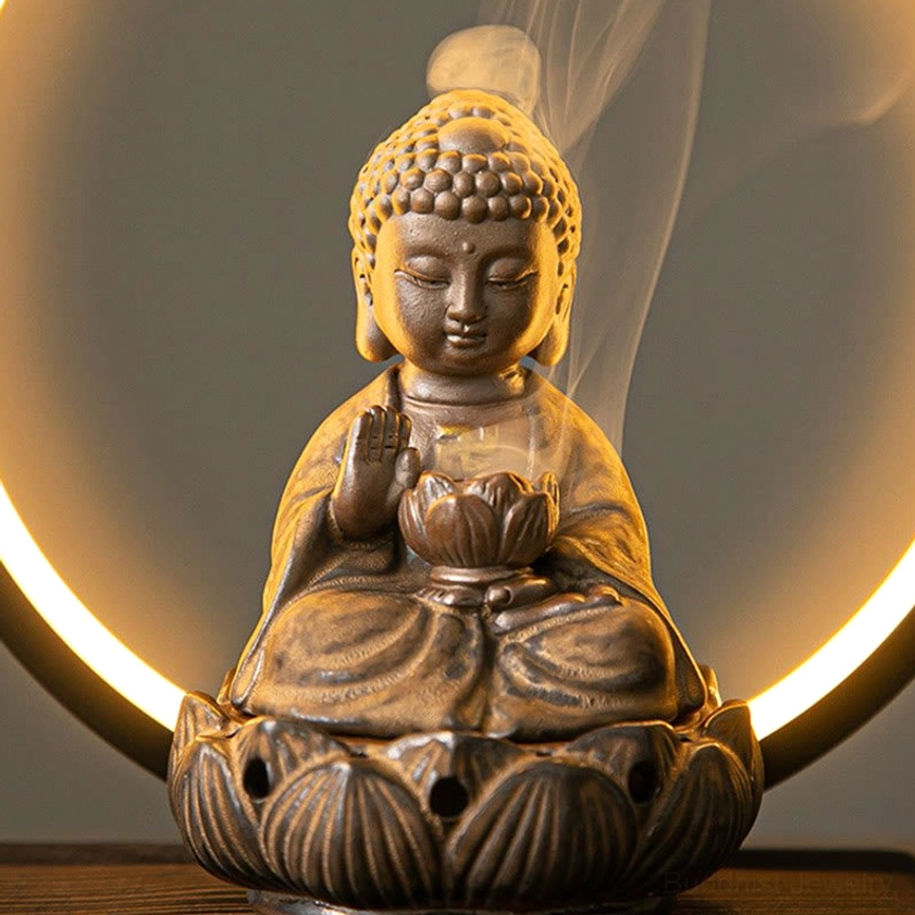 Close-up front view of brown natural ceramic Buddhist incense burner showing robe details and lotus incense vessel with smoke
