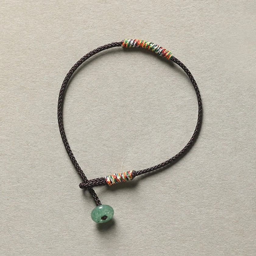 Brown braided Buddhist string bracelet with green aventurine bead for protection and balance, handmade spiritual jewelry
