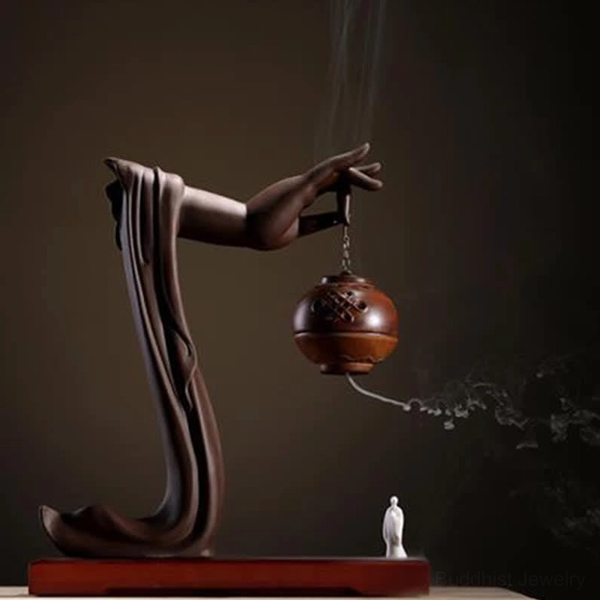 Brown ceramic Buddhist lotus hand incense burner with white zen figurine