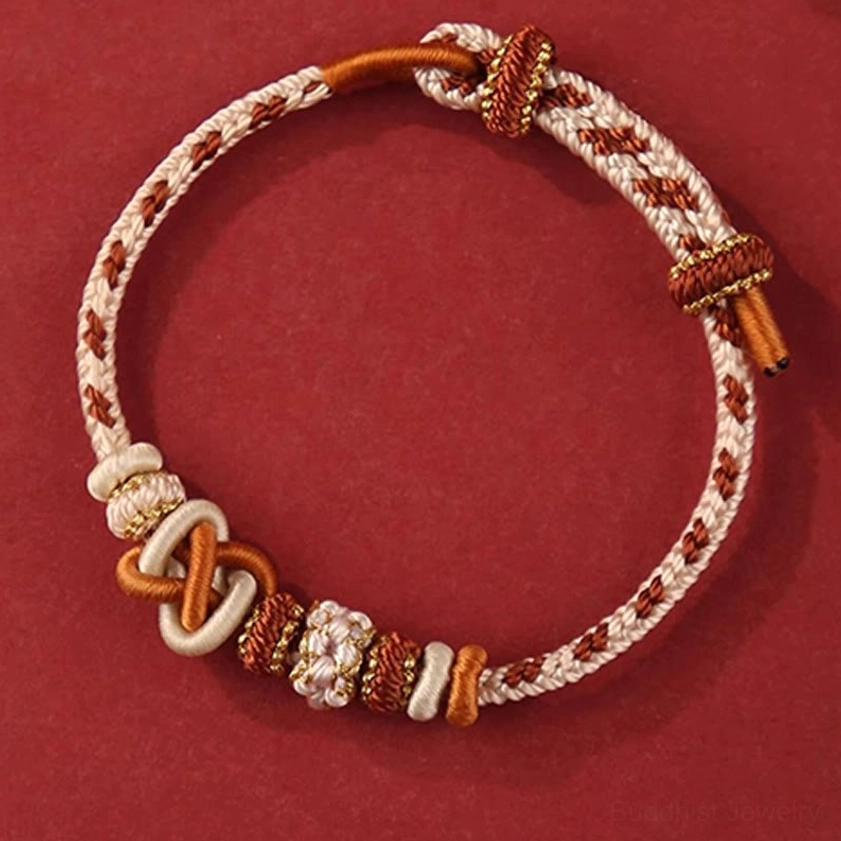 Brown cream and gold intricate peace knot Buddhist bracelet showing detailed braided woven design with precious metal accents