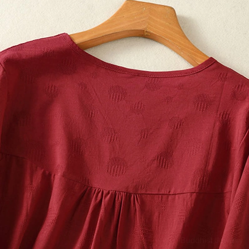 Crew neck detail of brown meditation yoga top - close-up showing premium cotton quality