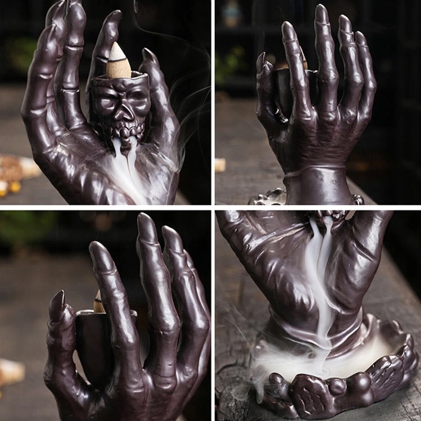 Side profile view of dark brown ceramic skull hand meditation incense burner