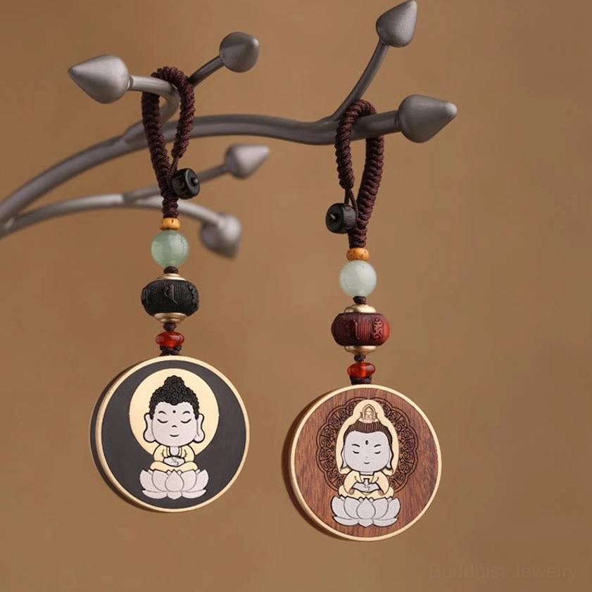Buddha and Avalokitesvara wooden keychains with beaded lanyards displayed on branch stand - Buddhist spiritual charm