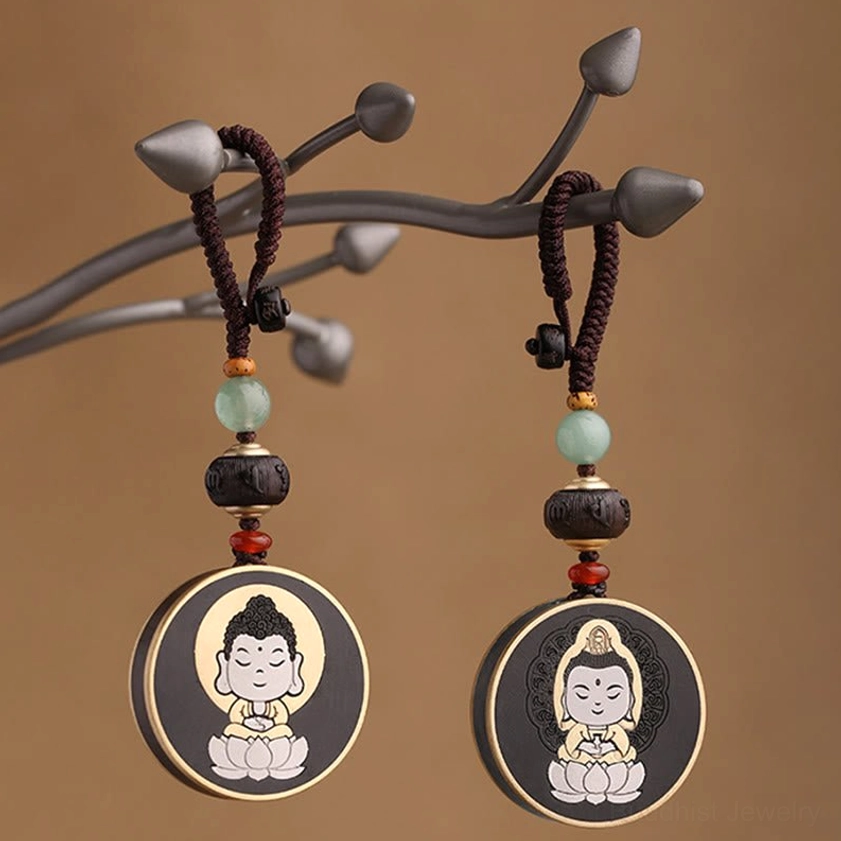 Buddha and Avalokitesvara keychain pair with matching beaded lanyards on wooden display stand