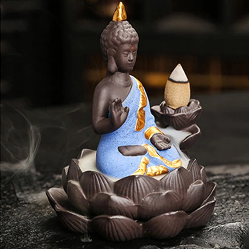 Buddha incense burner product lifestyle shot showing cascading backflow smoke waterfall effect in home setting