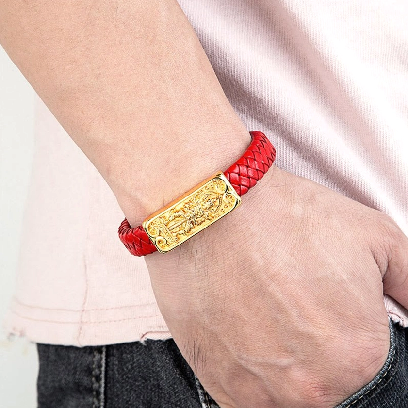 Person wearing red braided leather Buddha symbol bracelet with gold charm in daily wear demonstration