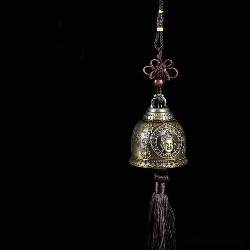 Buddha embossed handcrafted wind chime bell with bronze finish and Chinese knot tassel, front close-up view