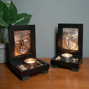 Bronze Buddha tealight candle holder front view with lit candle on wooden tabletop - meditation altar decor