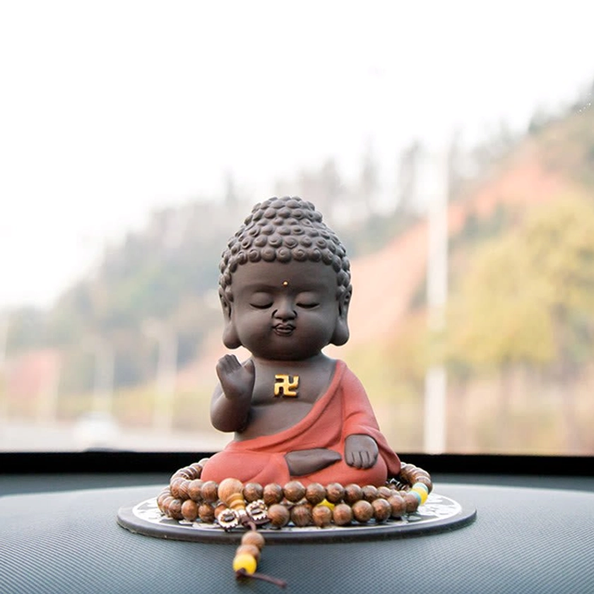 Car dashboard Buddha decor with prayer beads ornament displayed on windshield, matte finish natural purple clay material, travel protection symbol