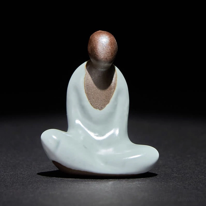 Handcrafted ceramic Buddha statue three-quarter view showing smooth glazed surface and details