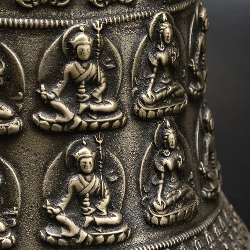 Detailed side view showing two rows of seated Buddha relief statues with raised embossed bronze texture