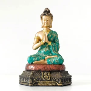Handcrafted Buddha compassion resin statue with gold body and teal embroidered robe, front full-body view on light tabletop