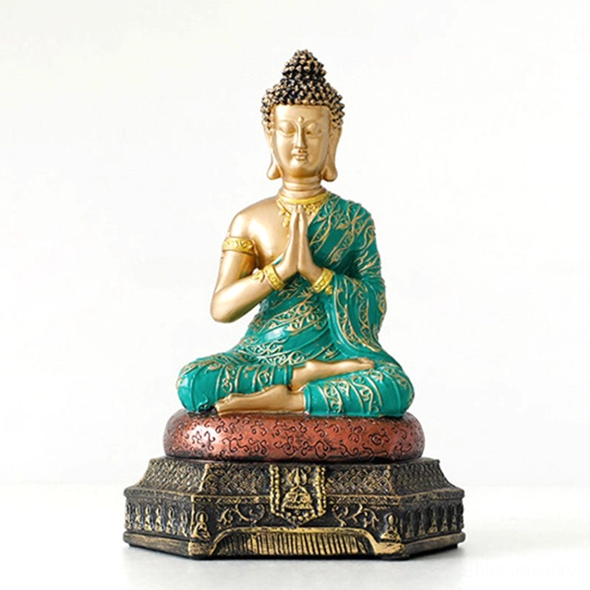 Handcrafted Buddha compassion resin statue with gold body and teal embroidered robe, front full-body view on light tabletop