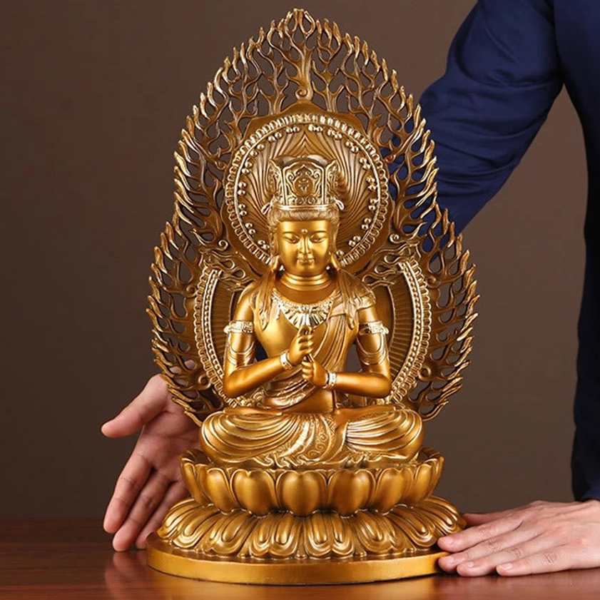 Seated Buddha statue with hand size reference showing intricate carved details and traditional meditation pose on wooden display surface