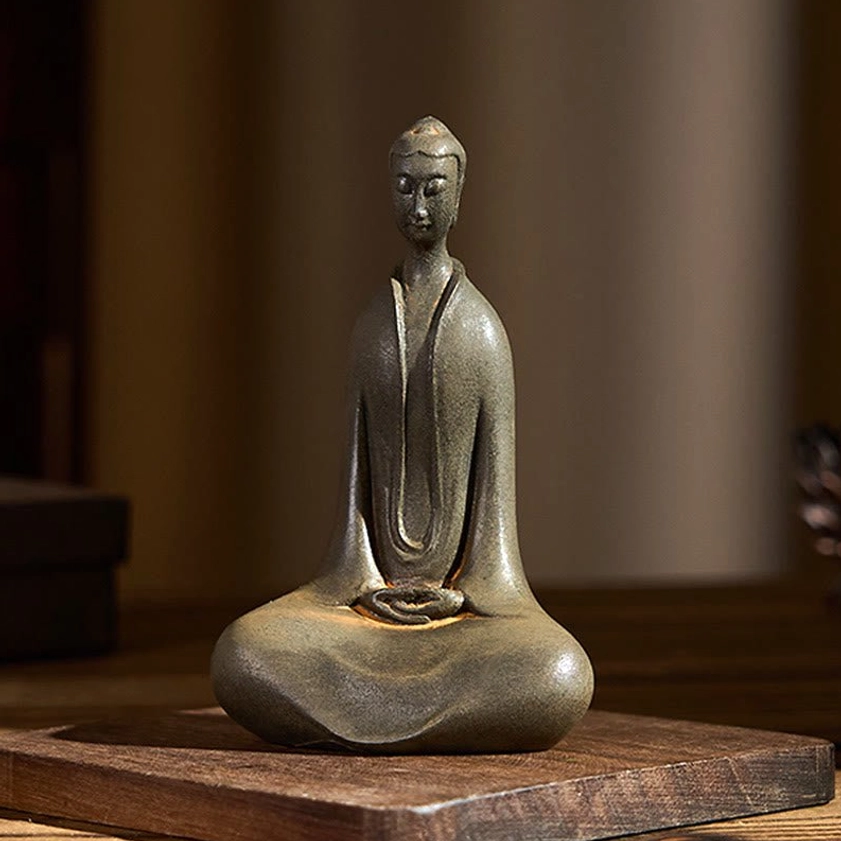Buddha ornament displayed on wooden base, traditional feng shui home decoration setting