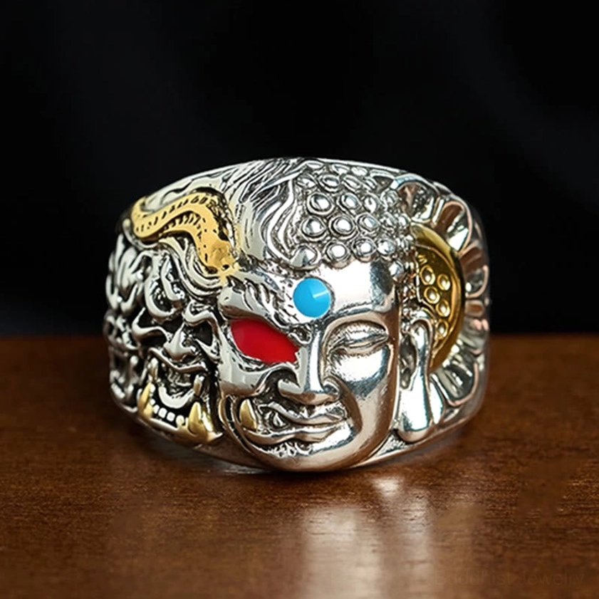 Half demon half Buddha lotus copper adjustable ring with turquoise and red agate inlay, front overhead view showing dual-face carving and intricate relief design
