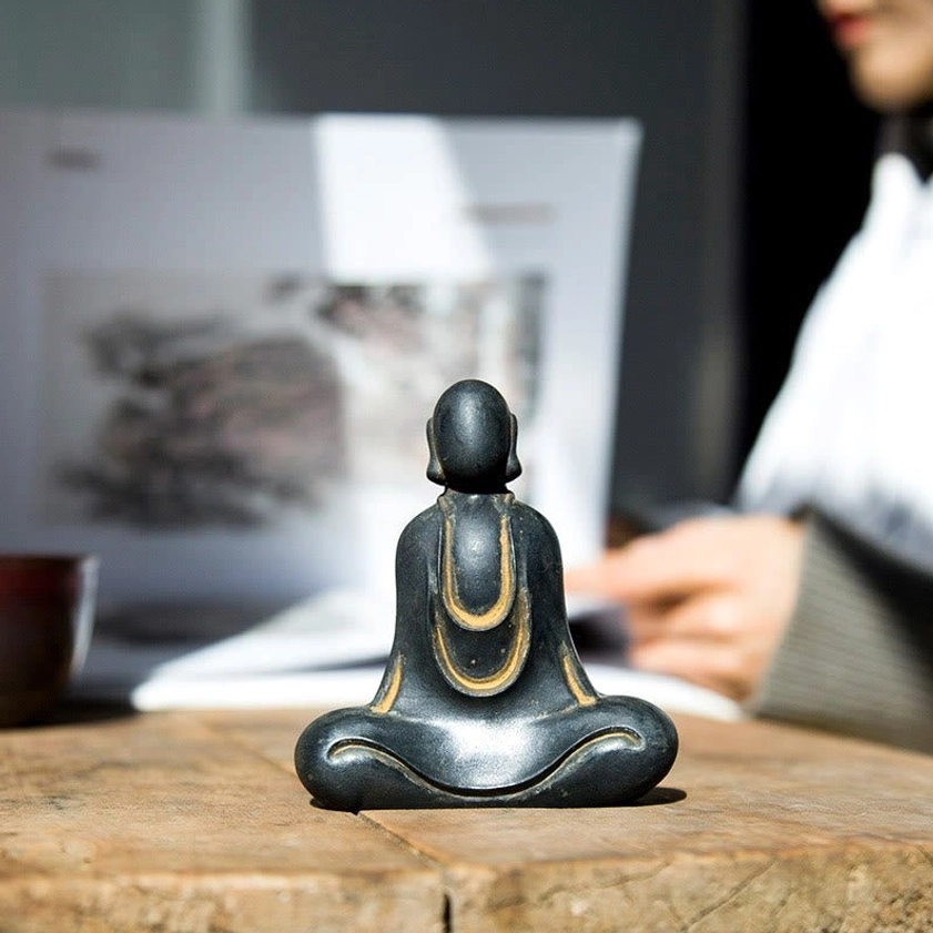Buddha desk statue showing authentic aged metal finish and feng shui decorative appeal