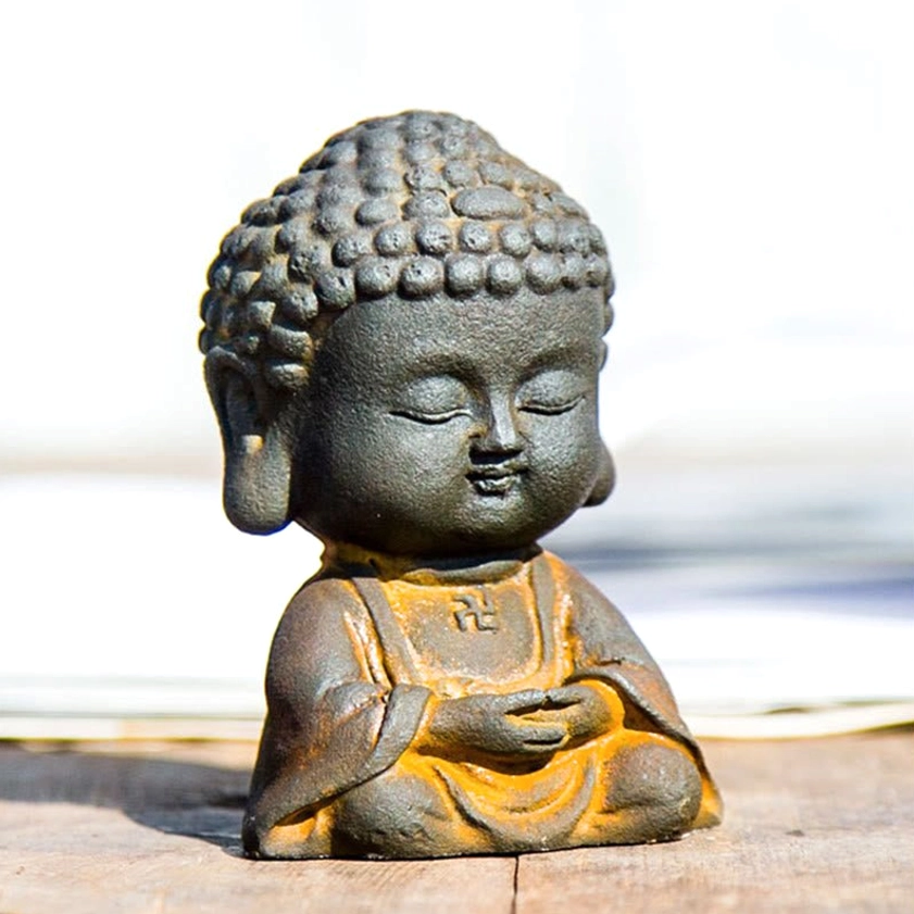 Extreme close-up of Buddha statue face showing detailed curled hair texture and peaceful closed-eye expression