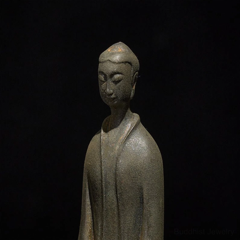 Close-up detail of Buddha statue face showing carved facial features and serene expression