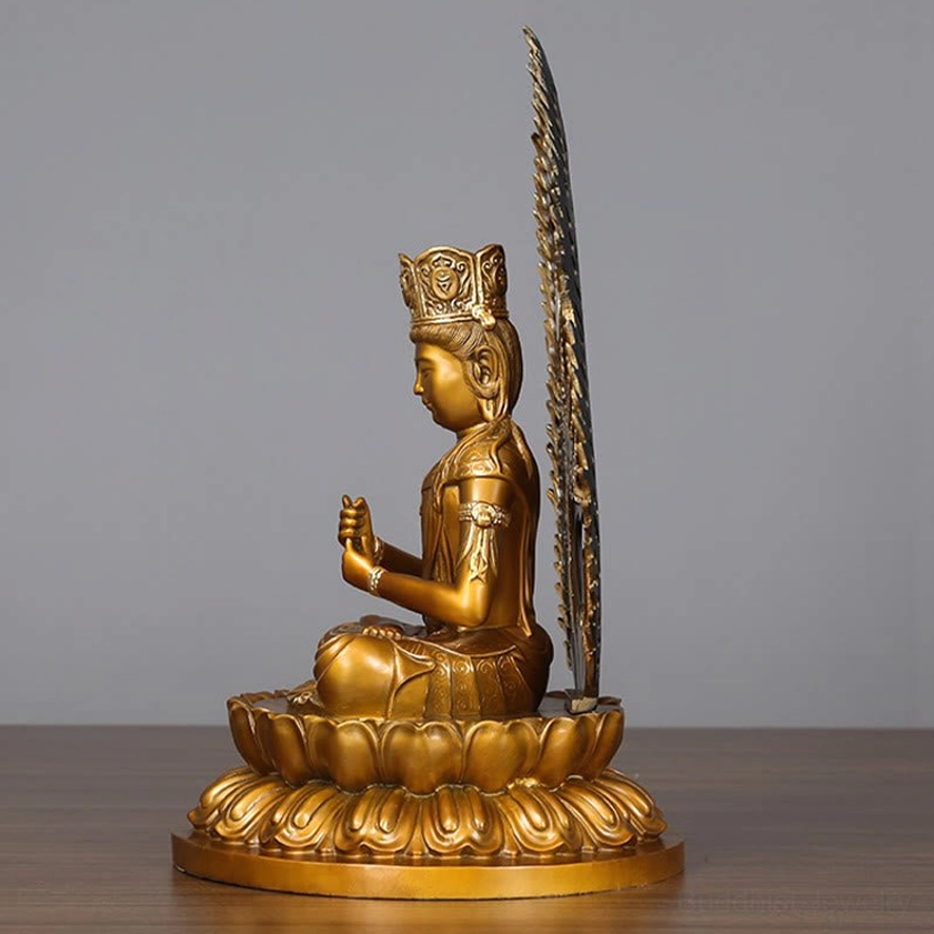 Left profile view of handmade Buddha copper statue with tall decorative back halo ornament and seated lotus position