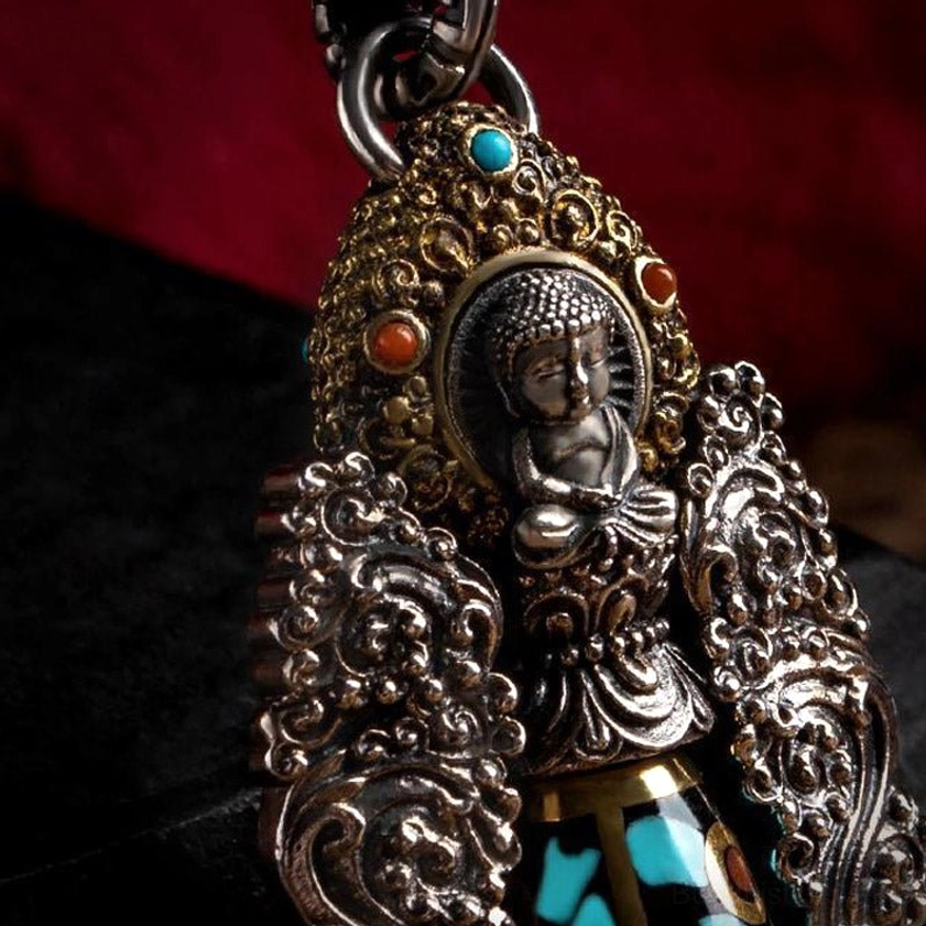 Seated buddha figurine pendant with inlaid turquoise and red gemstones, ornate gold trim, showcasing authentic handmade spiritual craftsmanship