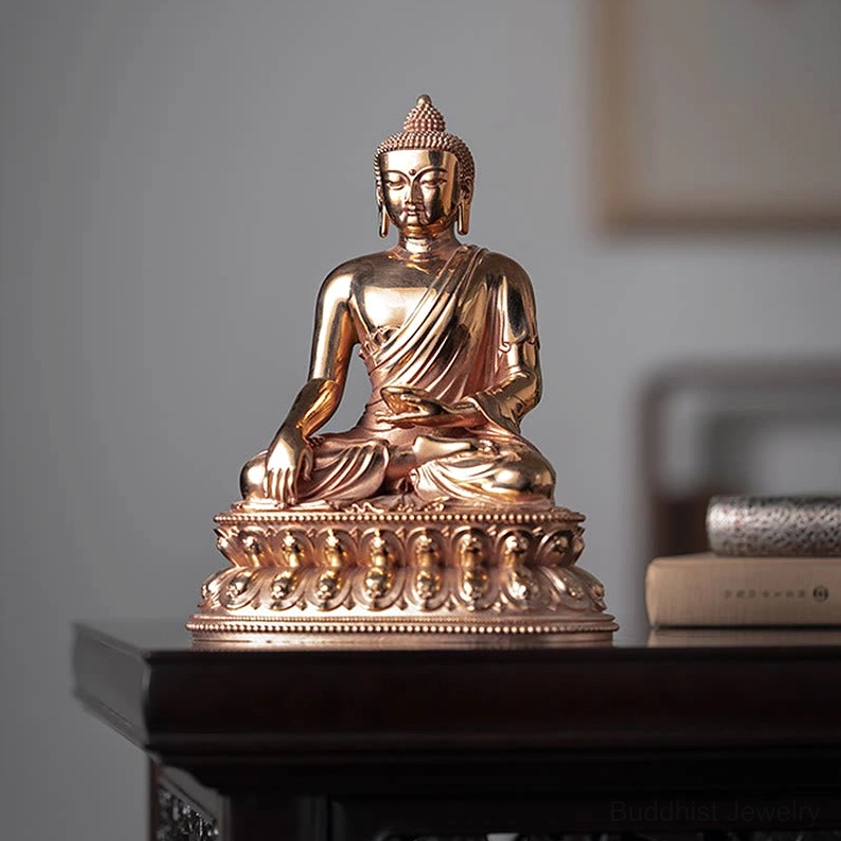 Full seated Shakyamuni Buddha statue on shelf display with polished rose copper finish
